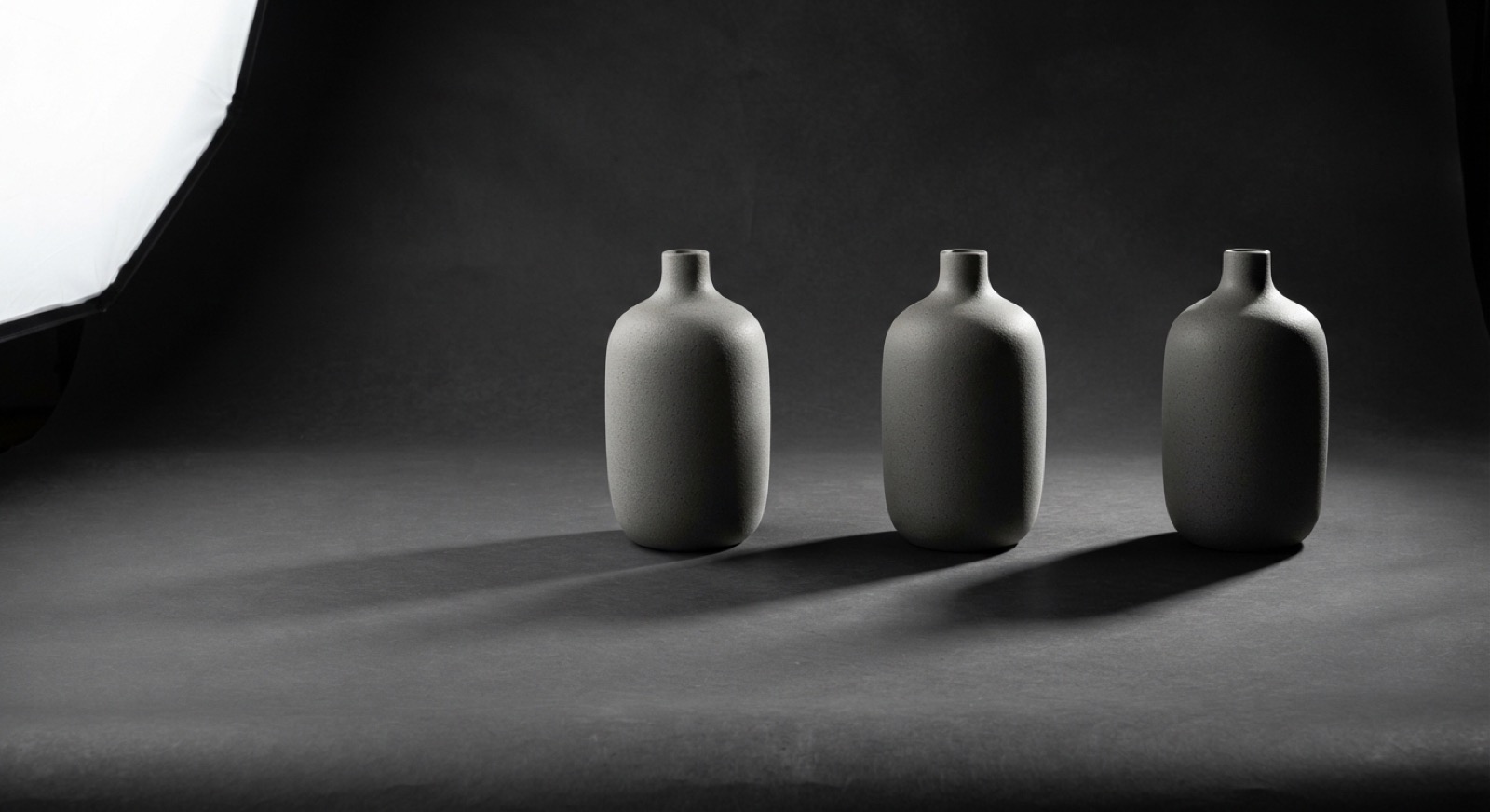 Fig. 1 — the same ceramic vase under a 1:1, a 2:1 and an 8:1 key-to-fill ratio. Nothing else in the prompt changed.